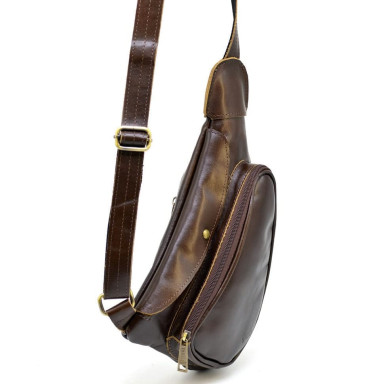 Leather backpack TARWA AC-3026-3md on one shoulder with a patch pocket