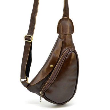 Leather backpack TARWA AC-3026-3md on one shoulder with a patch pocket