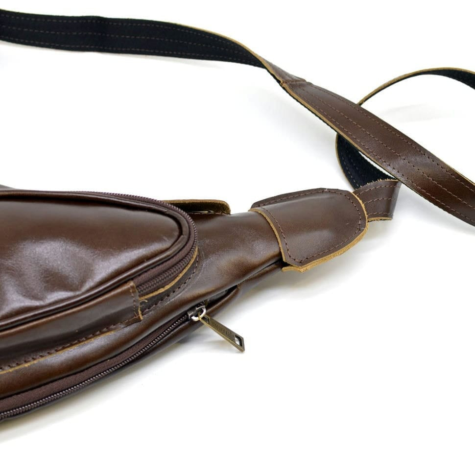 Leather backpack TARWA AC-3026-3md on one shoulder with a patch pocket