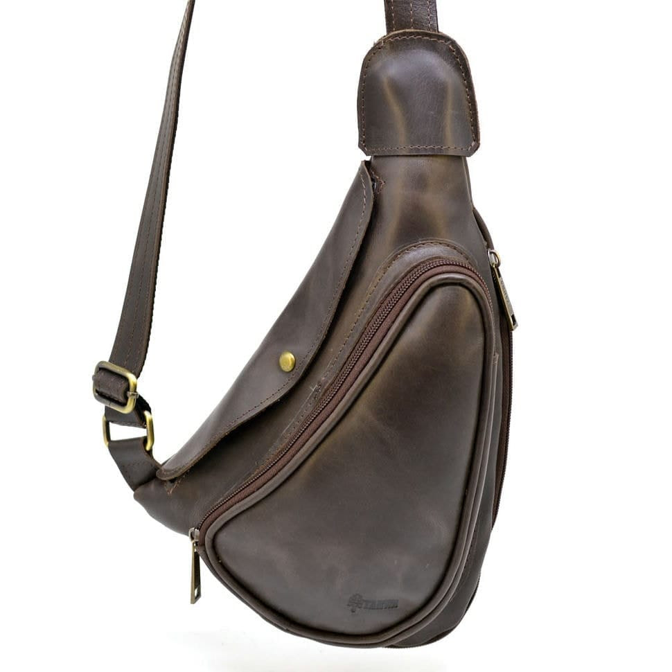 Leather backpack TARWA TC-3026-3md on one shoulder with a patch pocket