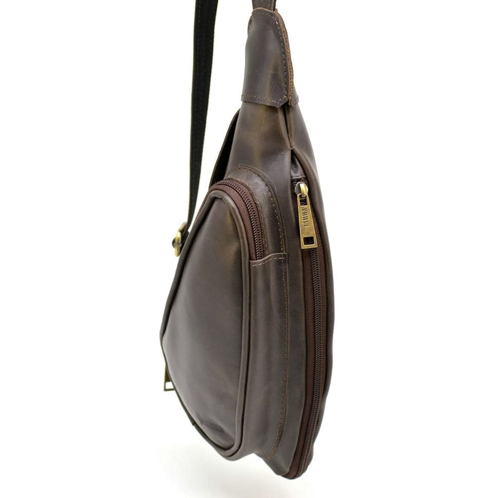 Leather backpack TARWA TC-3026-3md on one shoulder with a patch pocket