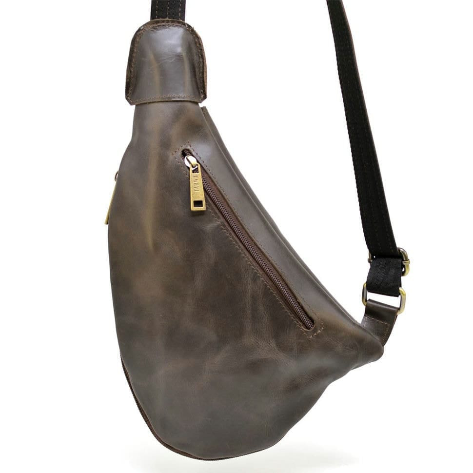 Leather backpack TARWA TC-3026-3md on one shoulder with a patch pocket