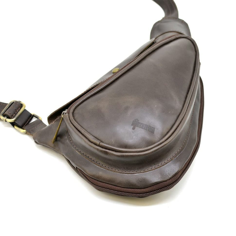 Leather backpack TARWA TC-3026-3md on one shoulder with a patch pocket