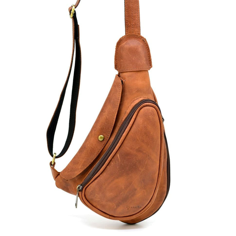Leather backpack TARWA RB-3026-3md on one shoulder with a patch pocket