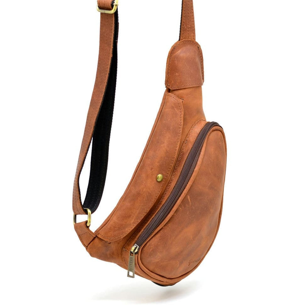 Leather backpack TARWA RB-3026-3md on one shoulder with a patch pocket