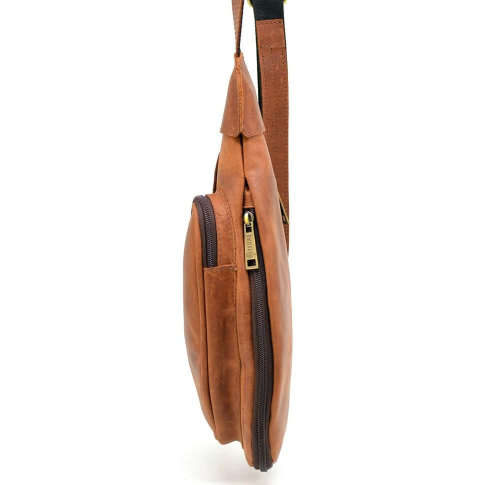 Leather backpack TARWA RB-3026-3md on one shoulder with a patch pocket