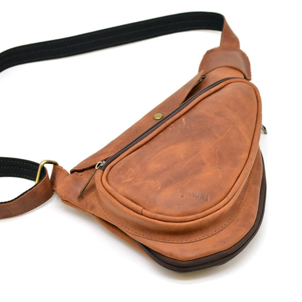 Leather backpack TARWA RB-3026-3md on one shoulder with a patch pocket