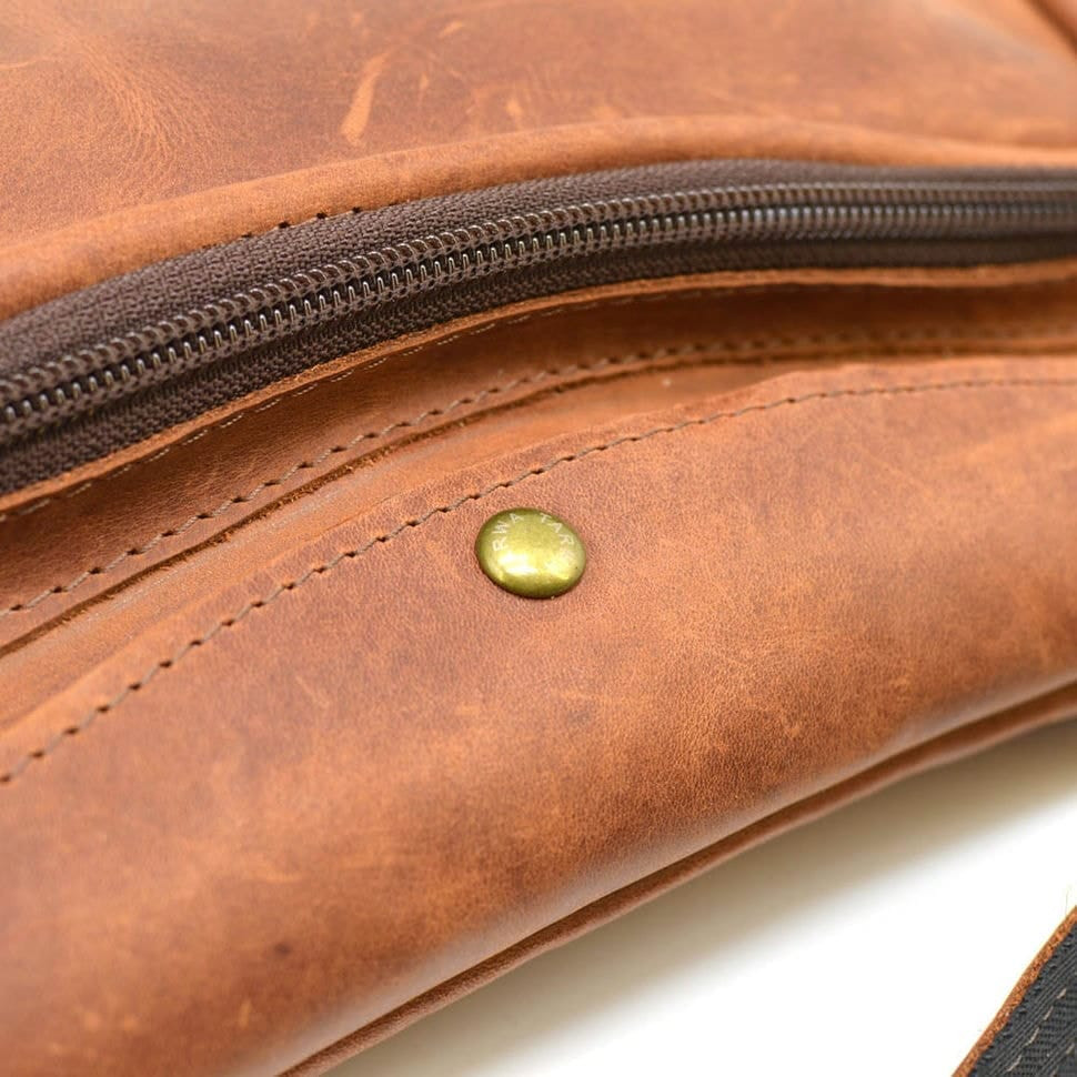 Leather backpack TARWA RB-3026-3md on one shoulder with a patch pocket